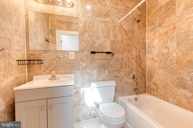 a bathroom with a sink toilet vanity and shower