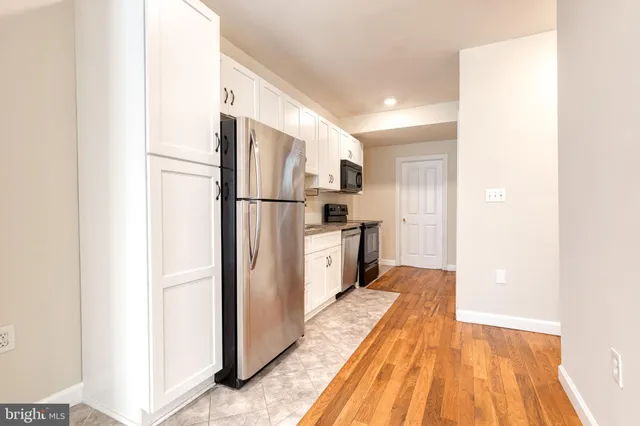 a kitchen with stainless steel appliances a refrigerator and a stove