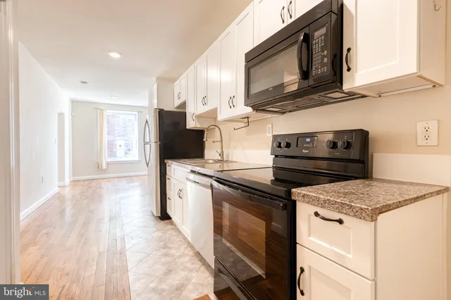 a kitchen with a stove microwave and refrigerator