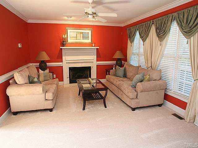 9109 Dawnshire Road Raleigh, NC 27615 - Photo 2 of 12 a living room with furniture a fireplace and a large window
