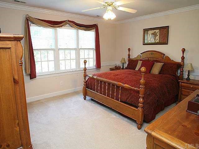 9109 Dawnshire Road Raleigh, NC 27615 - Photo 6 of 12 a bedroom with a bed and a window