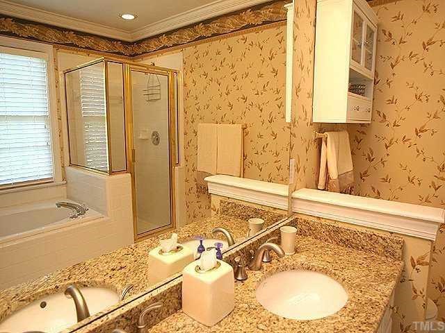 9109 Dawnshire Road Raleigh, NC 27615 - Photo 7 of 12 a bathroom with a granite countertop sink and a mirror