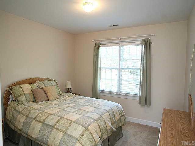 9109 Dawnshire Road Raleigh, NC 27615 - Photo 9 of 12 a bedroom with a bed and a window