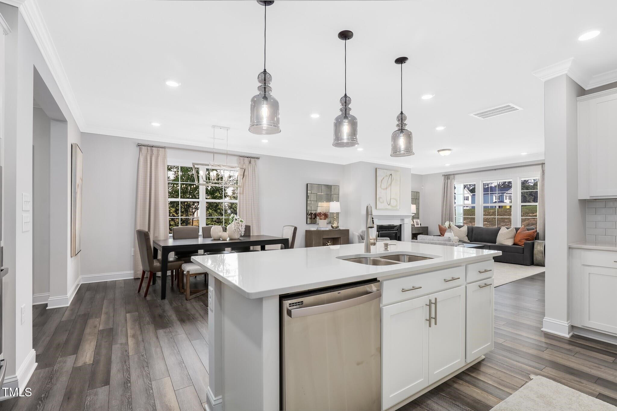 361 Calvander Lane Apex, NC 27539 - Photo 8 of 47 a kitchen with a stove a sink a dining table and chairs