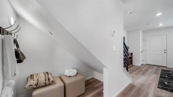 a view of a livingroom with furniture and stairs