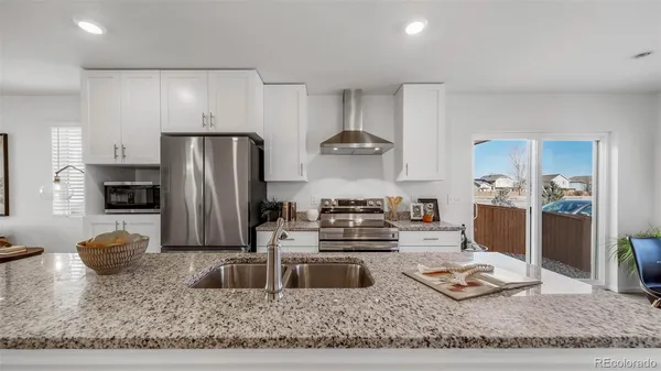 a kitchen with a refrigerator sink and stove
