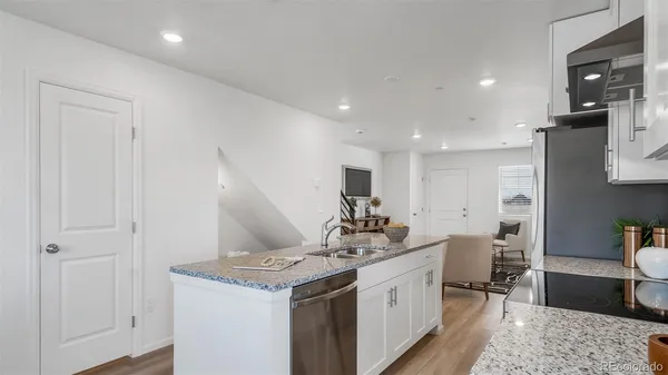 a kitchen with a sink stove and cabinets