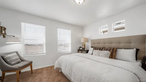 a bedroom with a bed and a chair