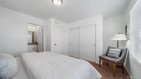 a bedroom with a bed and a chair