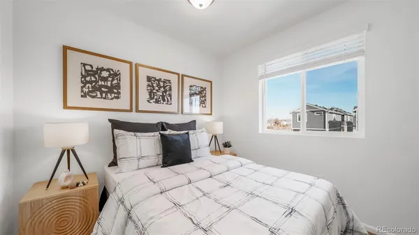 a bedroom with a bed and a painting on the wall