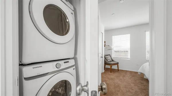 a view of a storage and utility room with washer and dryer