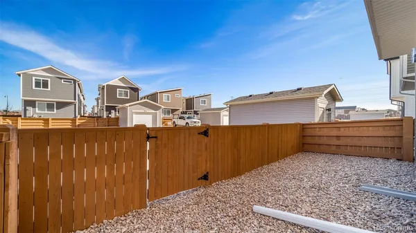 a view of a house with a wooden fence