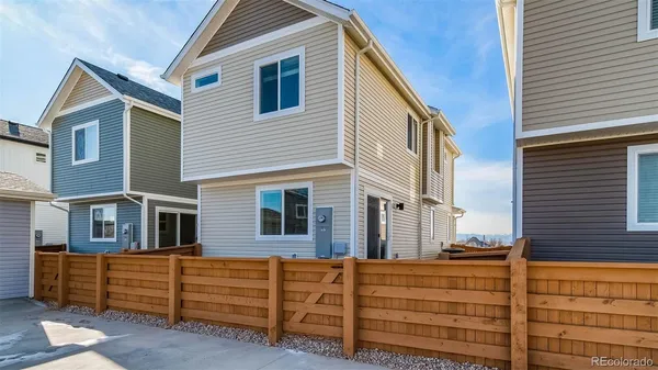 a view of a house with a wooden fence
