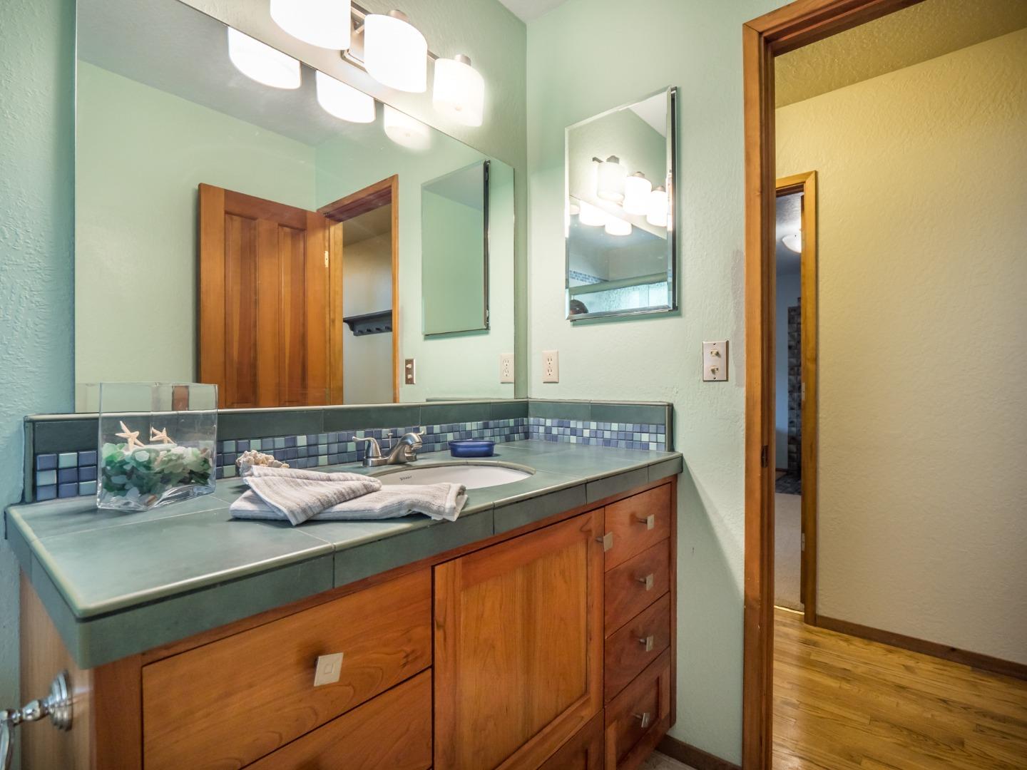 303 White Road Watsonville, CA 95076 - Photo 22 of 34 a bathroom with a sink and a mirror