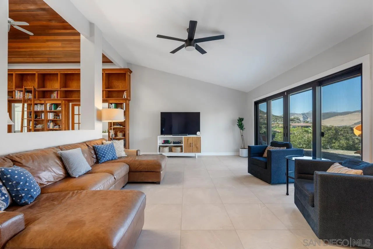 11869 Hi Ridge Road Lakeside, CA 92040 - Photo 22 of 73 a living room with furniture a flat screen tv and a large window