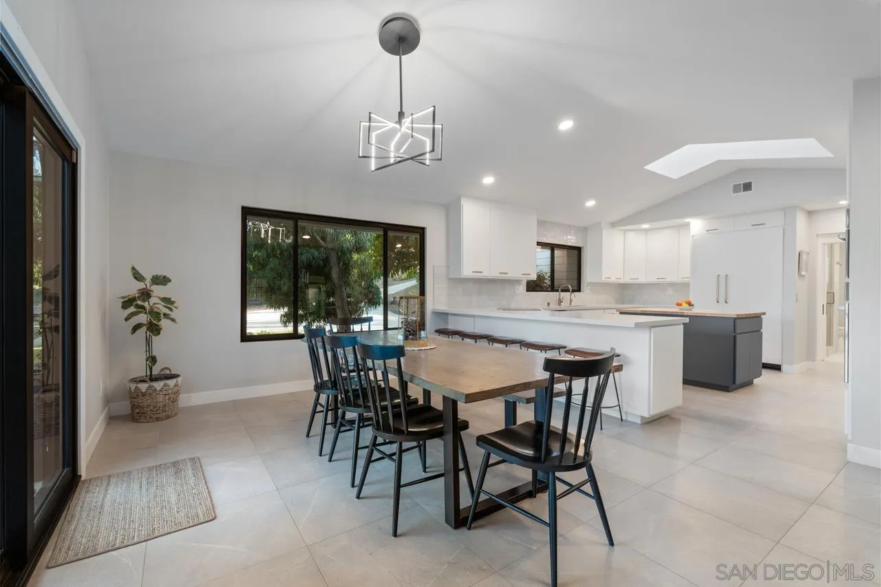 11869 Hi Ridge Road Lakeside, CA 92040 - Photo 25 of 73 a dining area with a table chairs and a kitchen view