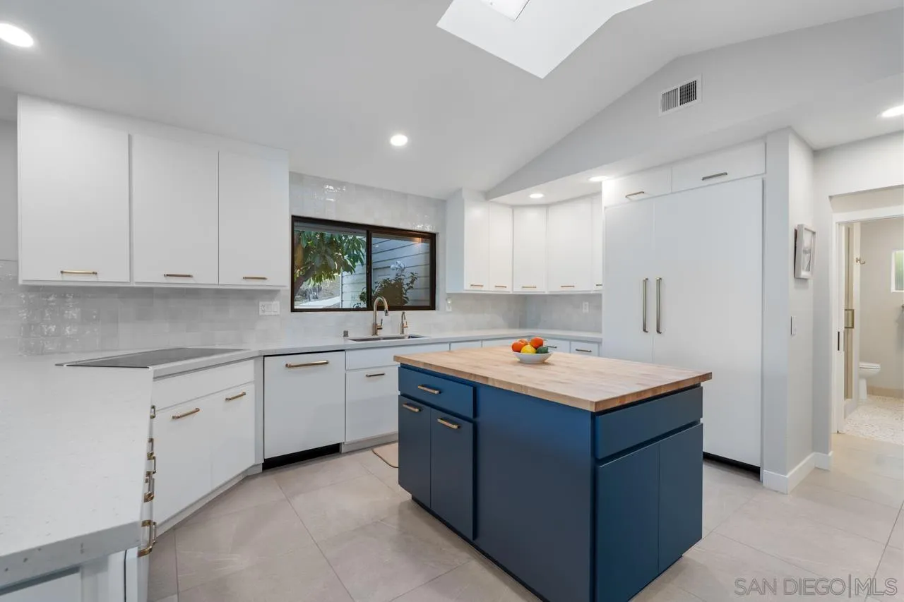 11869 Hi Ridge Road Lakeside, CA 92040 - Photo 28 of 73 a kitchen that has a lot of white cabinets and stainless steel appliances