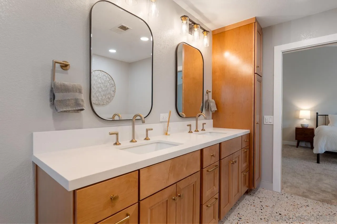 11869 Hi Ridge Road Lakeside, CA 92040 - Photo 45 of 73 a en suite bathroom with a double vanity sink and a mirror