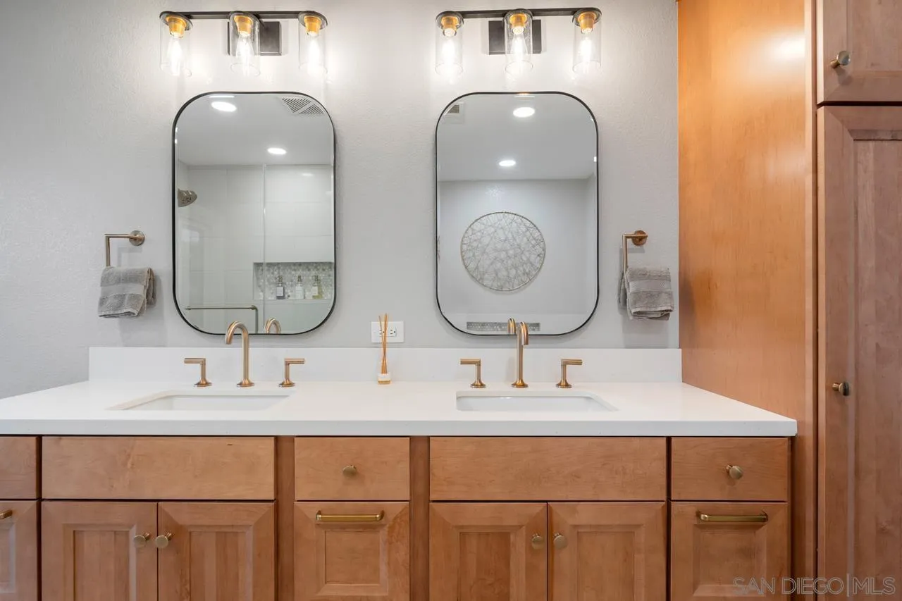 11869 Hi Ridge Road Lakeside, CA 92040 - Photo 46 of 73 a bathroom with double vanity sinks and a mirror