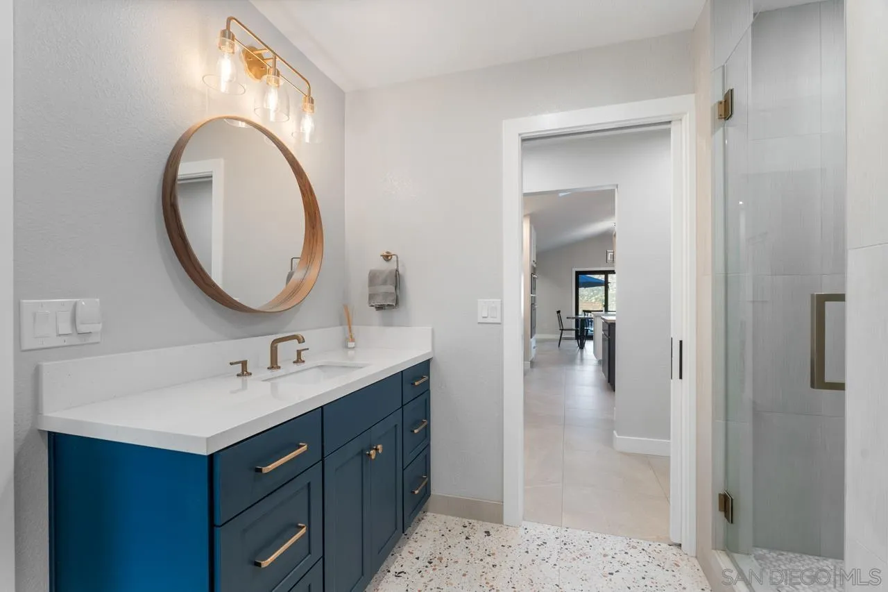 11869 Hi Ridge Road Lakeside, CA 92040 - Photo 49 of 73 a bathroom with a sink vanity and a mirror