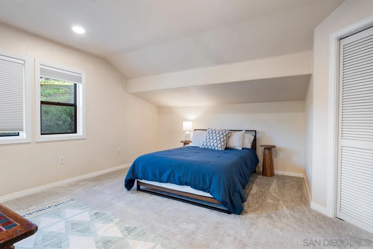 11869 Hi Ridge Road Lakeside, CA 92040 - Photo 56 of 73 a bedroom with a bed and a window