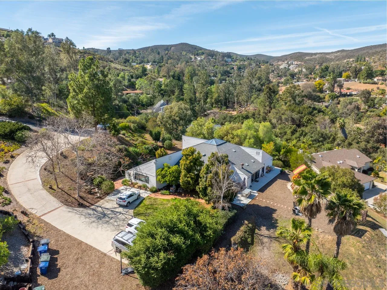11869 Hi Ridge Road Lakeside, CA 92040 - Photo 9 of 73 an aerial view of green landscape with trees houses and mountain view