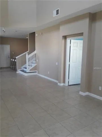 a view of an empty room and a window
