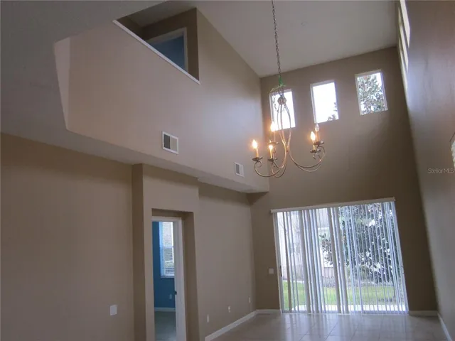 a kitchen with a table chairs and a refrigerator