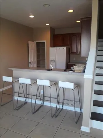 a kitchen with a refrigerator sink and cabinets