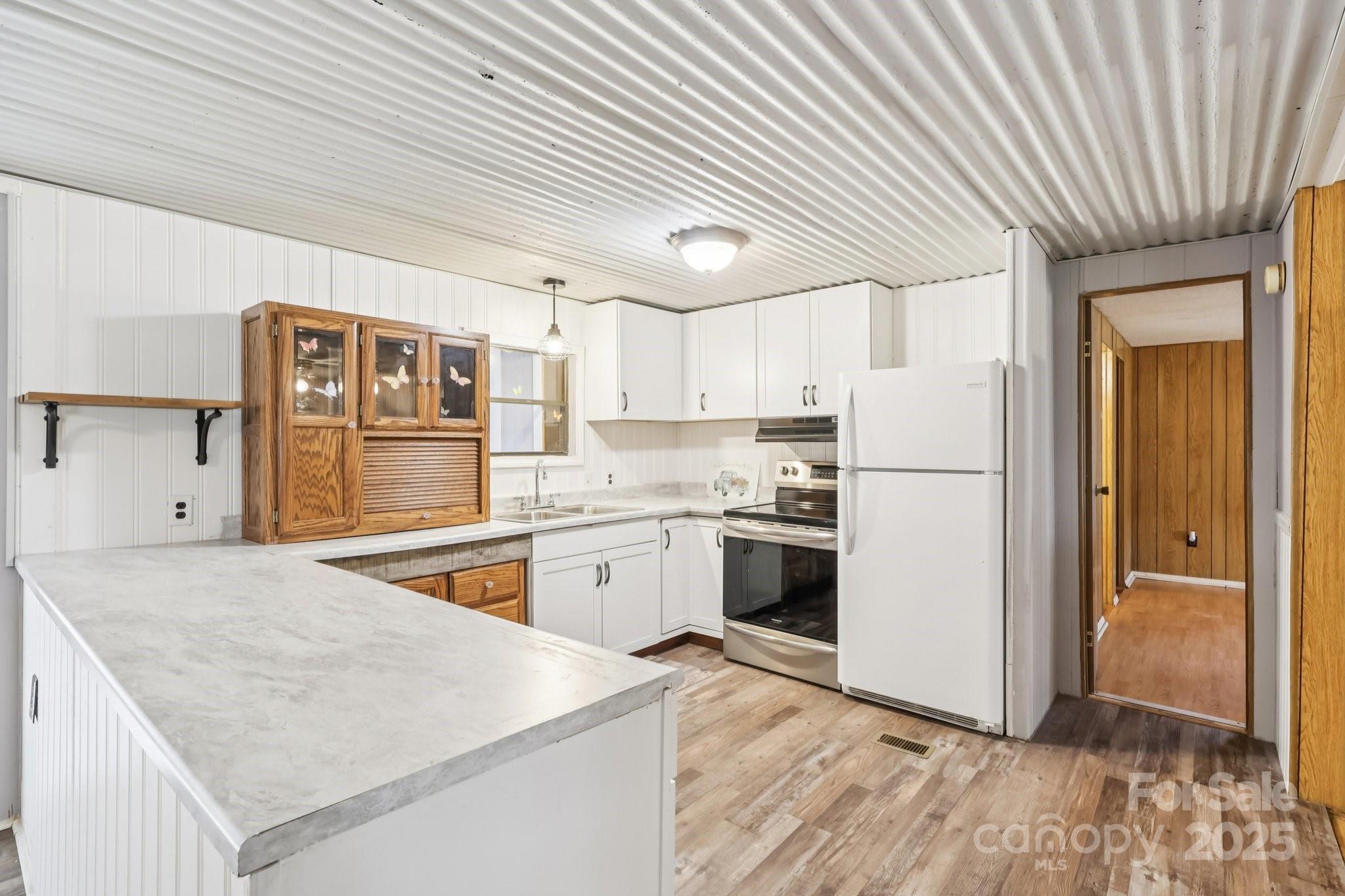 920 Dewitt Helms Road Monroe, NC 28112 - Photo 14 of 47 a kitchen with stainless steel appliances granite countertop a refrigerator a sink dishwasher a stove and white countertops with wooden floor
