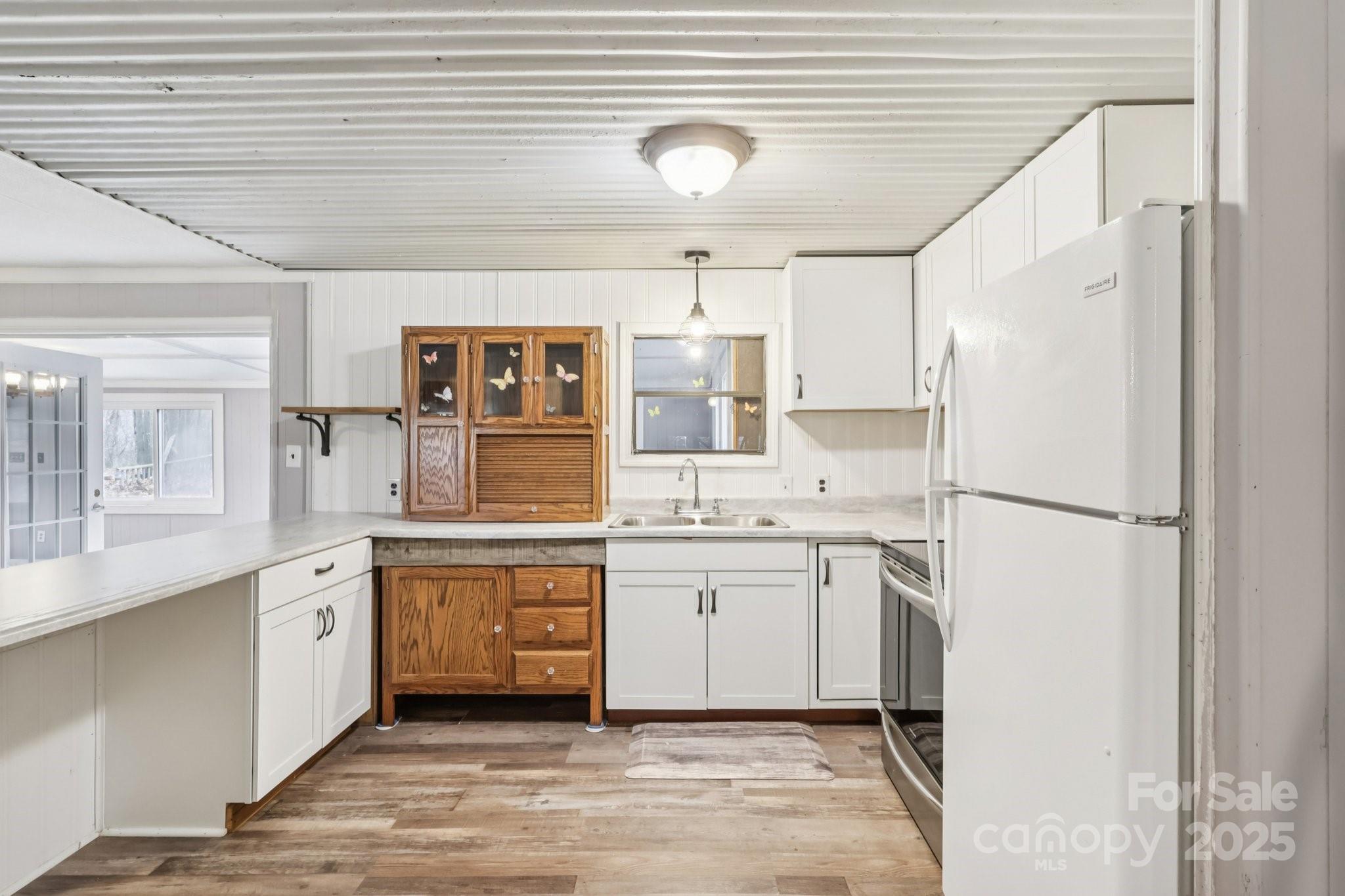 920 Dewitt Helms Road Monroe, NC 28112 - Photo 15 of 47 a kitchen with white cabinets and white appliances