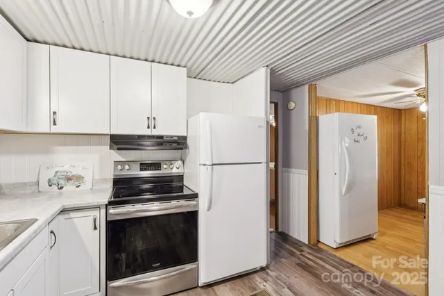 a kitchen with stainless steel appliances granite countertop a sink and cabinets