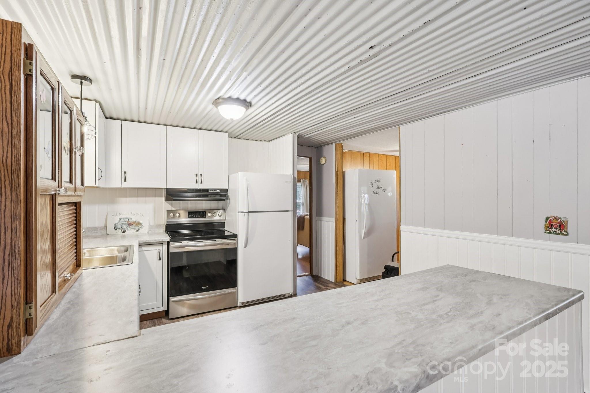 920 Dewitt Helms Road Monroe, NC 28112 - Photo 18 of 47 a kitchen with stainless steel appliances granite countertop a refrigerator a sink dishwasher a stove and white countertops with wooden floor