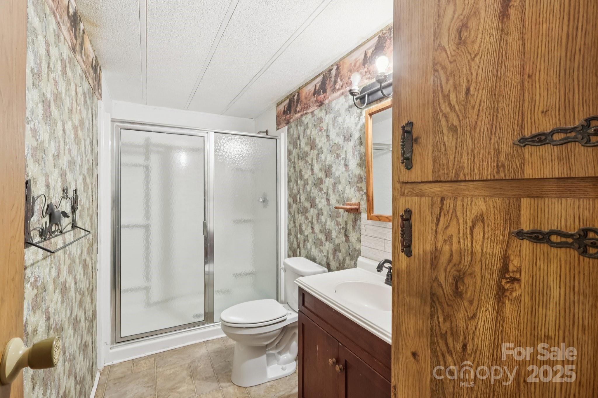 920 Dewitt Helms Road Monroe, NC 28112 - Photo 20 of 47 a bathroom with a shower curtain a sink and a toilet