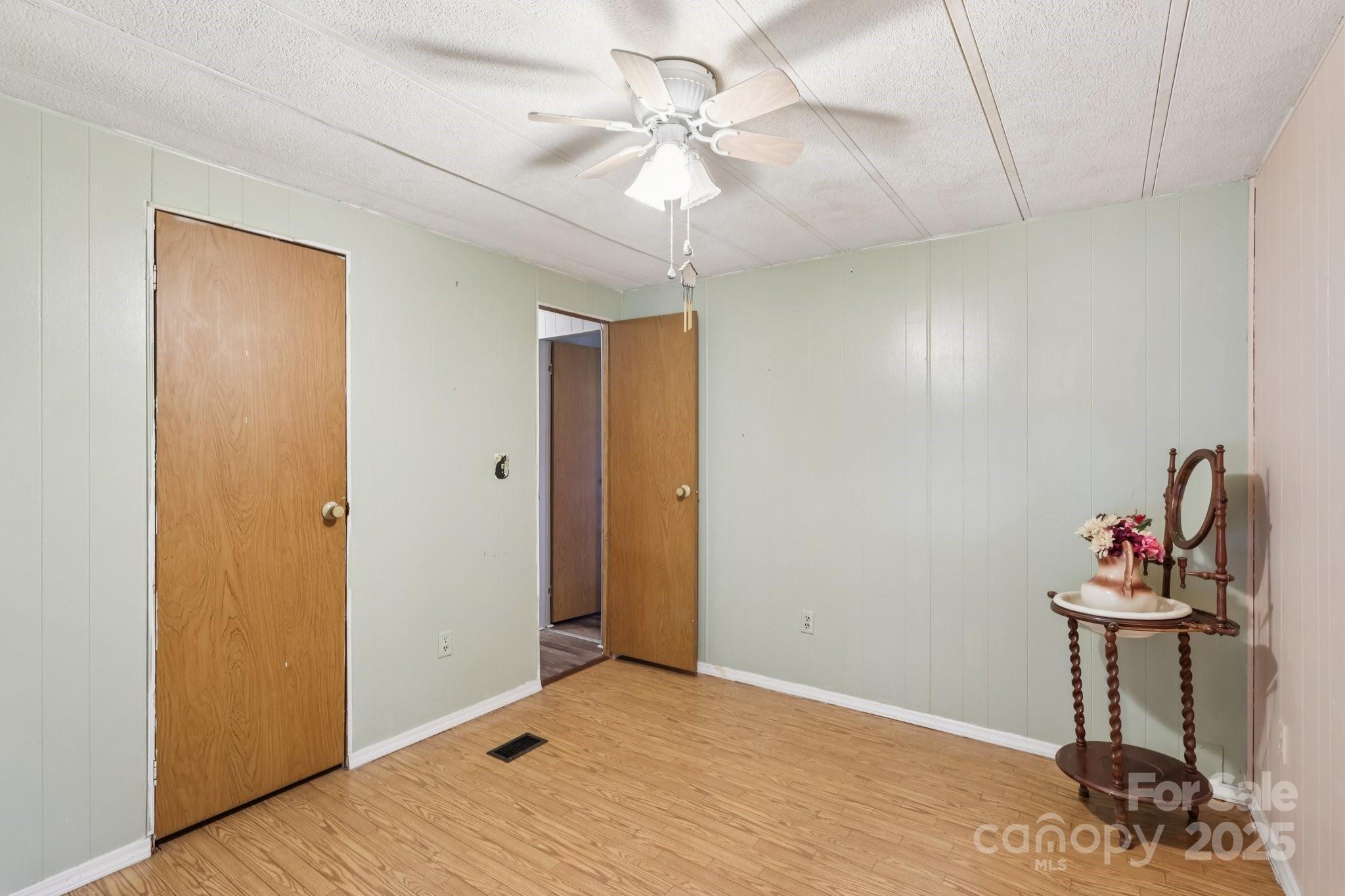 920 Dewitt Helms Road Monroe, NC 28112 - Photo 25 of 47 a view of a room with a chandelier fan and wooden floor