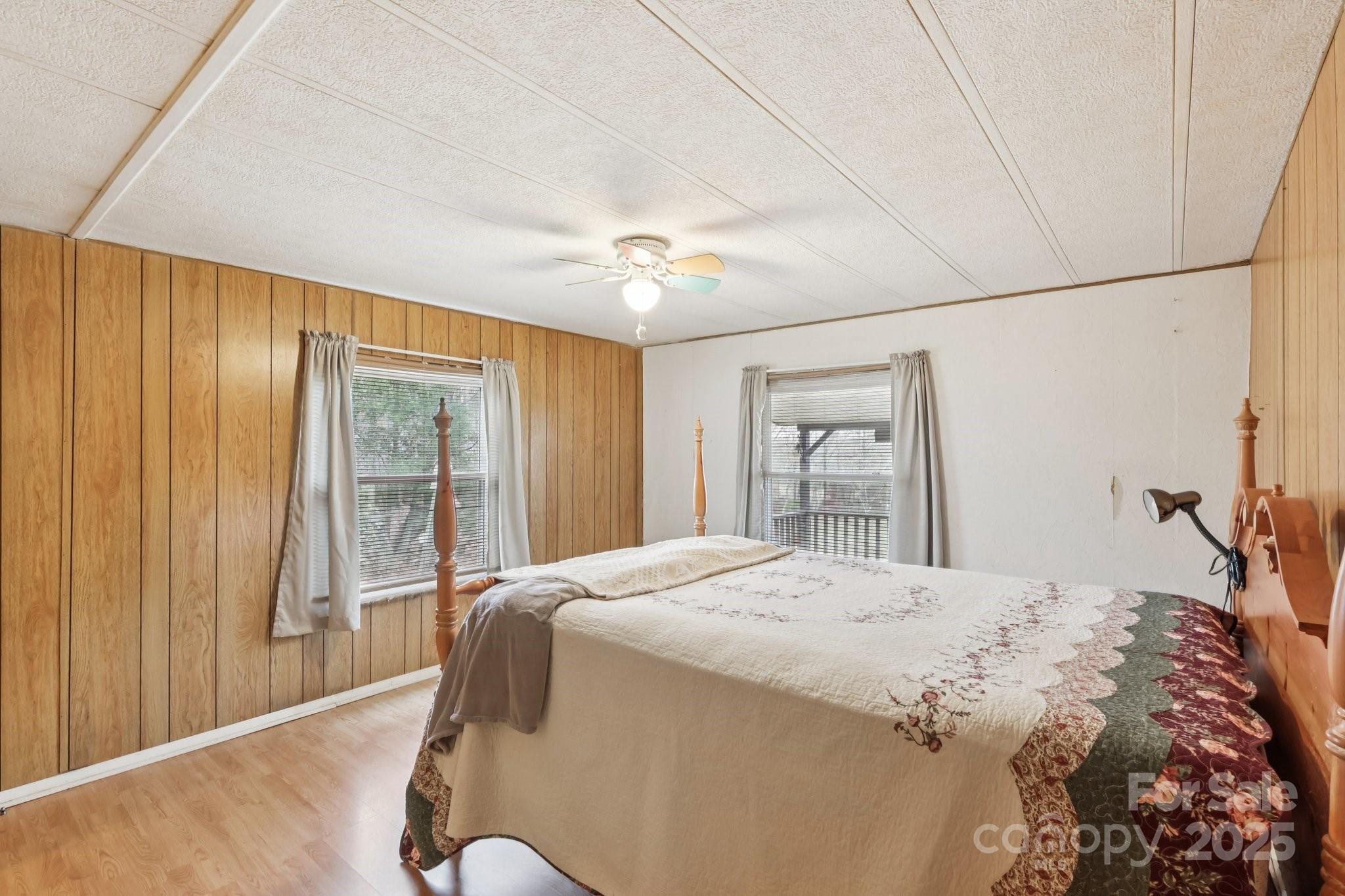 920 Dewitt Helms Road Monroe, NC 28112 - Photo 29 of 47 a bedroom with a large bed and a chandelier