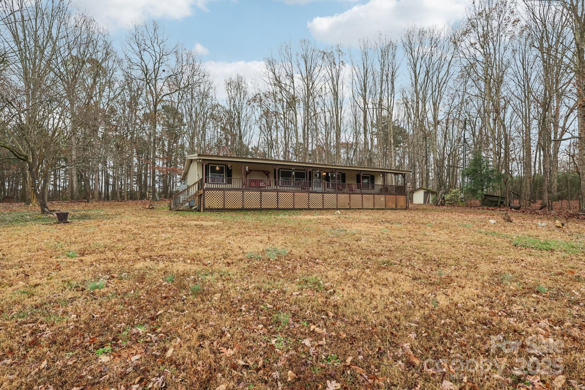 920 Dewitt Helms Road Monroe, NC 28112 - Photo 3 of 47 a view of swimming pool with trees in the background