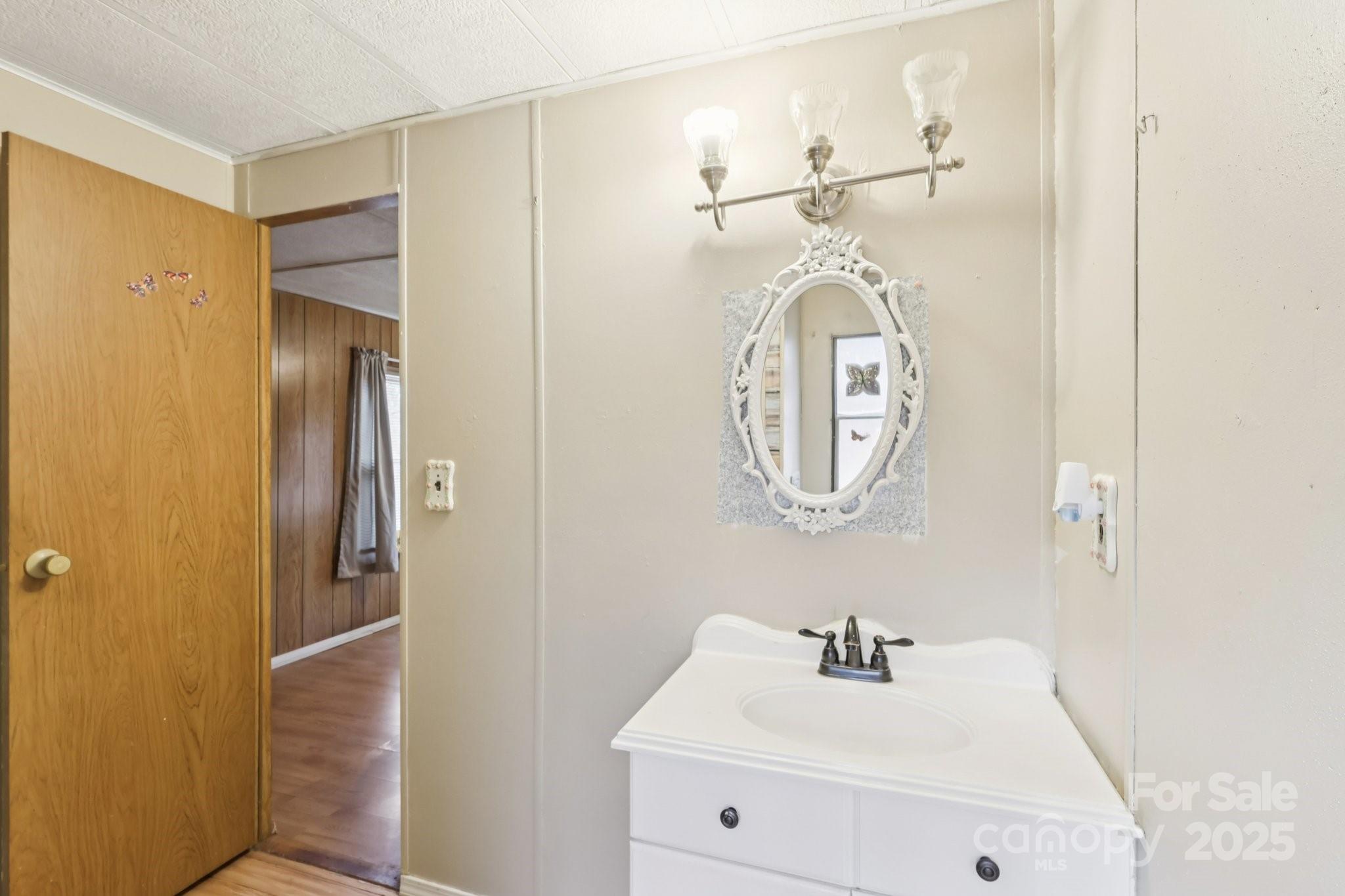 920 Dewitt Helms Road Monroe, NC 28112 - Photo 32 of 47 a bathroom with a sink and a mirror