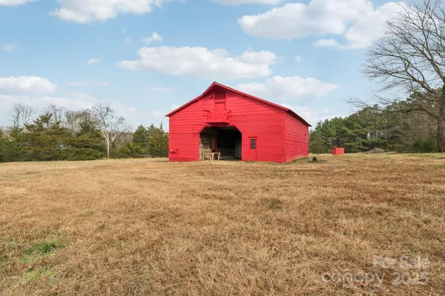 an aerial view of a houses with a yard