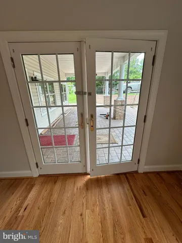 an empty room with wooden floor and door