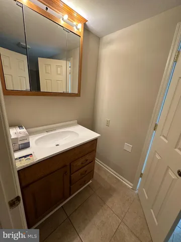 a room with a sink and a mirror