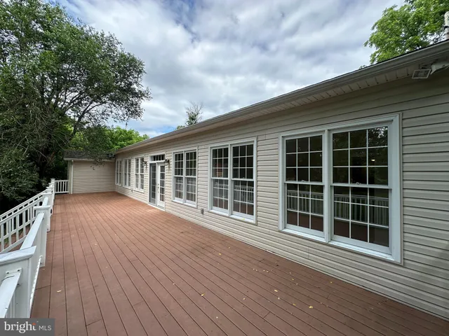 a view of backyard with deck and wooden floor