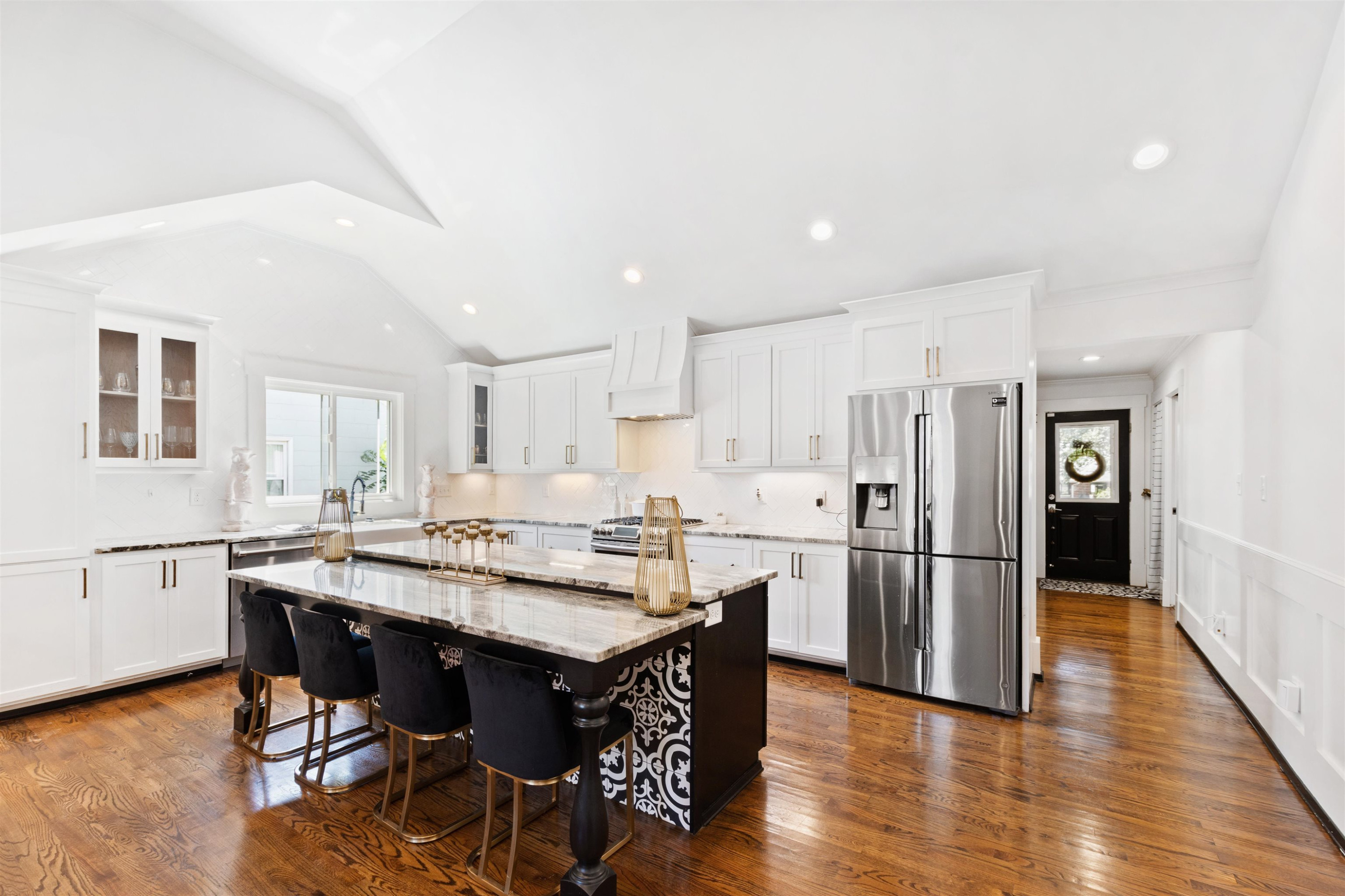 1715 Center Road Raleigh, NC 27608 - Photo 3 of 34 a kitchen with stainless steel appliances granite countertop a dining table chairs refrigerator sink and cabinets