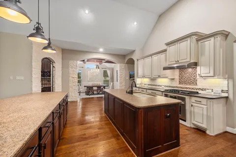a kitchen with stainless steel appliances granite countertop a stove oven and a refrigerator
