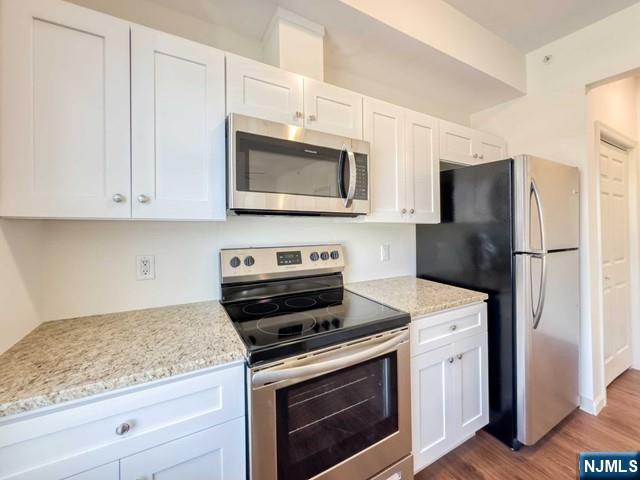 103 Johnson Avenue, Unit 203 Hackensack, NJ 07601 - Photo 3 of 13 a kitchen with cabinets stainless steel appliances and a counter space
