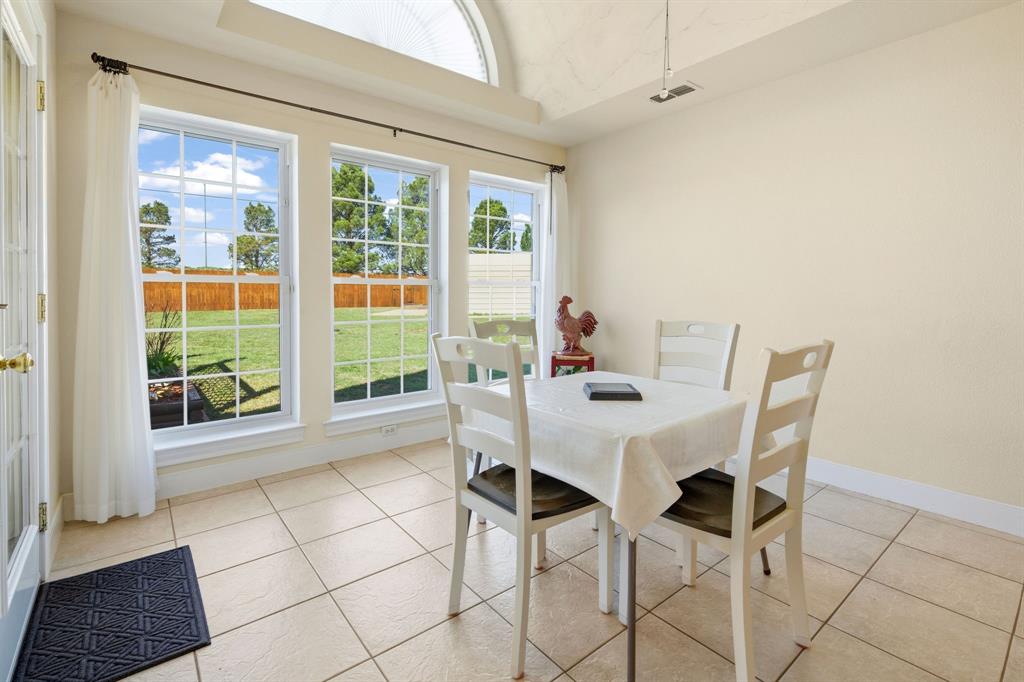 8718 Ranch Road Abilene, TX 79602 - Photo 20 of 40 Barrel ceiling, arched window and floor to ceiling windows make this dining area beautiful.