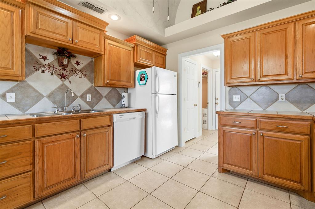 8718 Ranch Road Abilene, TX 79602 - Photo 25 of 40 Pantry door located next to refrigerator and next to it is the entrance to the laundry room.