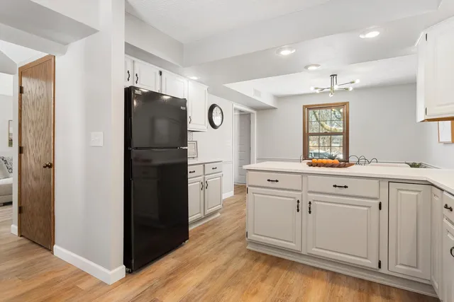 a kitchen with a refrigerator and a sink