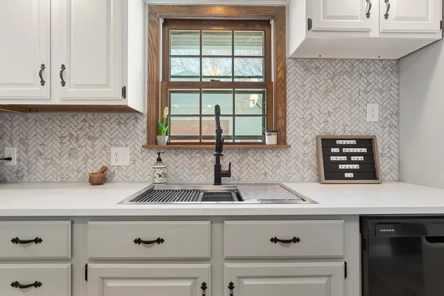 a kitchen with a sink and a window