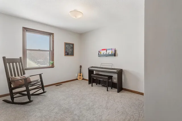 a view of a livingroom with furniture and a window